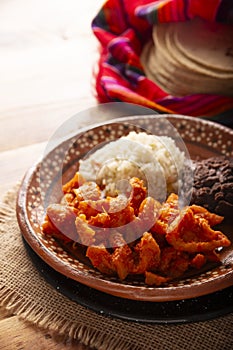 Chicharron en salsa roja mexican food recipe photo