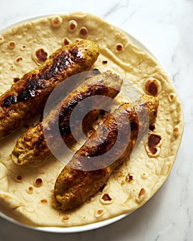 Chichen Persian Koobideh Kebab. Kebab with turmeric, onions, sumac, and other ingredients. On lavash bread