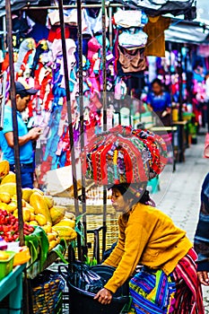 Chichicastenango, Guatemala on 2th May 2016 - Indingenous maya woman carry products on the top of her head