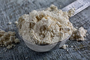 Chick pea flour closeup in measuring spoon