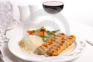 Chicken Adana Kebap Served with Rice Pilaf Vegetables and Red Vi