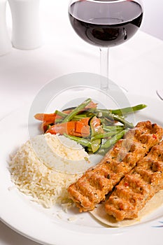 Chicken Adana Kebap Served with Rice Pilaf Vegetables and Red Vi