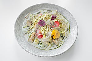 Chicken Alfredo served in a dish isolated on grey background top view