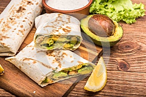 Chicken, avocado and vegetables burrito. photo