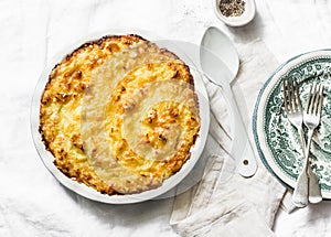 Chicken, bacon and leek cottage pie on a light background