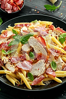 Chicken, bacon Penne pasta with parmesan cheese and basil. healthy food.