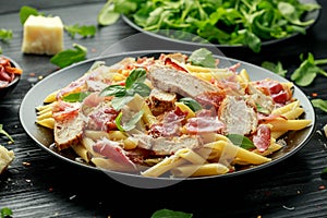 Chicken, bacon Penne pasta with parmesan cheese and basil. healthy food.