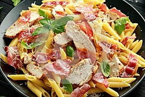 Chicken, bacon Penne pasta with parmesan cheese and basil. healthy food.