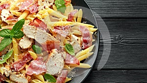 Chicken, bacon Penne pasta with parmesan cheese and basil. healthy food.