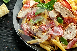 Chicken, bacon Penne pasta with parmesan cheese and basil. healthy food.