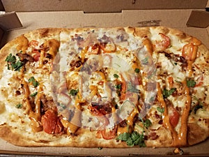 chicken and bacon pizza with spicy sauce in box