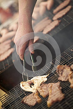 CHICKEN AND BEEF STEAKS ON BARBECUE WITH BEEF BURGERS