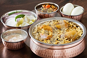 Chicken biryani with traditional sides