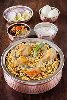 Chicken biryani with traditional sides
