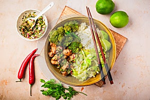 Chicken bowl with rice, broccoli, cabbage and green Chimmichurri salsa