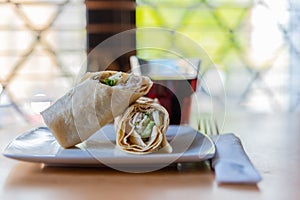 Chicken breast with caesar dressing and lettuce in a gluten-free tortilla wrap