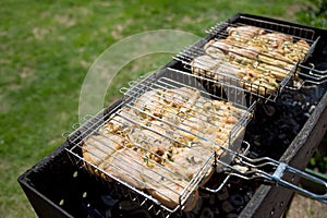 Chicken breast grilled with flames.Spicy marinated chicken wings and legs grilling on a summer barbecue with hot flames