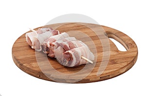 Chicken breast rolled in bacon on the kitchen round board