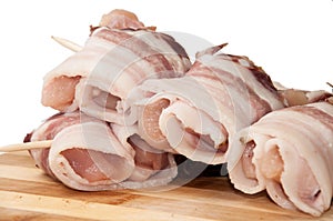 Chicken breast rolled in bacon on the wooden board