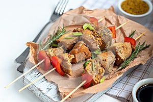 Chicken breast skewers with bell pepper. The meat is marinated in soy sauce with honey and mustard. Decorated with sprigs of