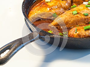 Chicken Breasts Cooking in a Cast Iron Pan