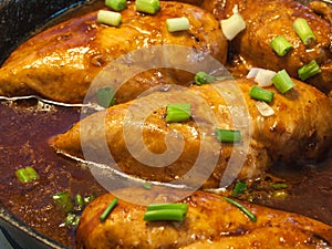 Chicken Breasts Cooking in a Cast Iron Pan