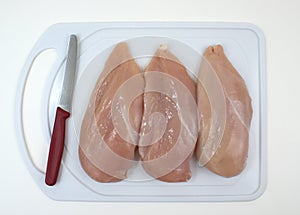 Chicken breasts on cutting board photo
