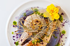 Chicken breasts elegantly served on white plate