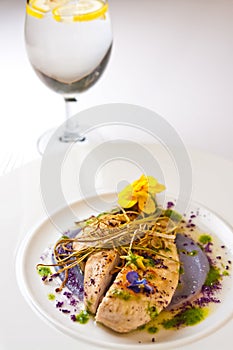 Chicken breasts elegantly served on white plate