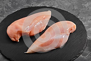 Chicken breasts, raw chicken fillet Photo for a store with natural products. Food delivery, gray background. copies of