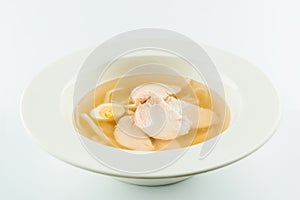 Chicken broth bouillon with quail eggs and noodles isolated on white background