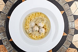 Chicken broth with meatballs and farfallina