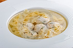 Chicken broth with meatballs and farfallina