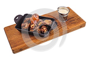 Chicken Buffalo Wings with sauce on wooden board