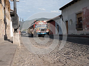 Chicken bus on a cobble stone street in Antigua guatemala