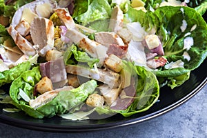 Chicken Caesar Salad in Black Bowl