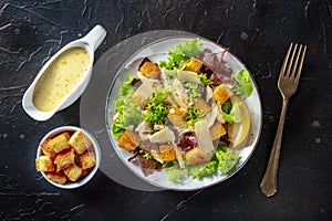 Chicken Caesar salad, overhead flat lay shot with the classic sauce