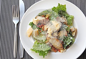 Chicken ceasar salad in a white plate