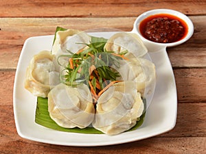 Chicken cheese momo. Nepalese Traditional dish Momo stuffed with chicken and cheese and then cooked and served over a rustic