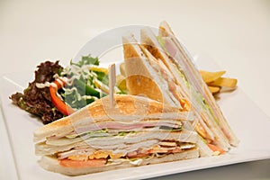 Chicken club sandwich with french fries