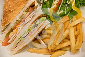 Chicken club sandwich with french fries