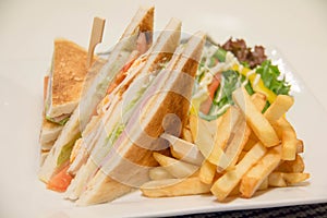 Chicken club sandwich with french fries