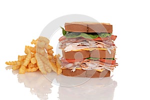 Chicken club sandwich with french fries