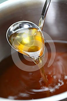 Chicken consomme soup in a pot