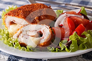 Chicken cordon bleu cut and a salad close-up. horizontal