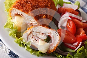 Chicken cordon bleu and fresh vegetable salad closeup. horizontal