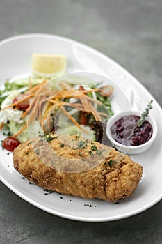 Chicken cordon bleu meal with salad in french restaurant