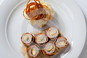 Chicken Cordon bleu on a plate with rustic mashed potatoes.