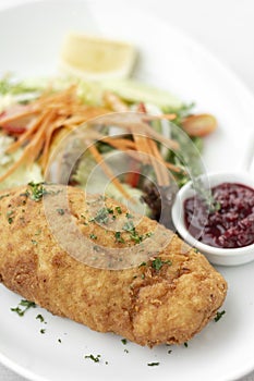 Chicken cordon bleu with salad and cranberry sauce