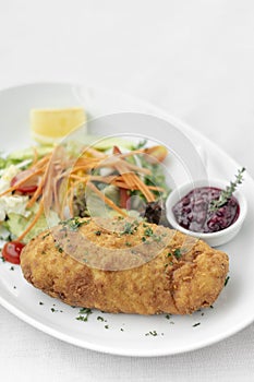 Chicken cordon bleu with salad and cranberry sauce